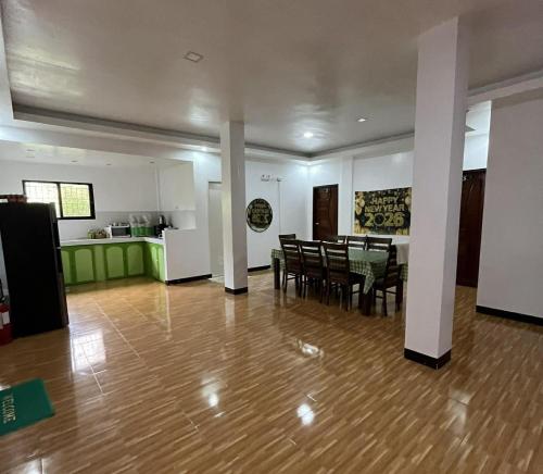 a living room with a table and chairs and a kitchen at Yena's Inn in Cauayan