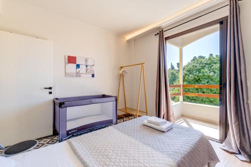 a bedroom with a bed and a large window at Eirini's Apartment in Kanoni