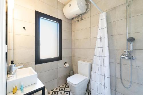a bathroom with a toilet and a sink and a shower at Eirini's Apartment in Kanoni