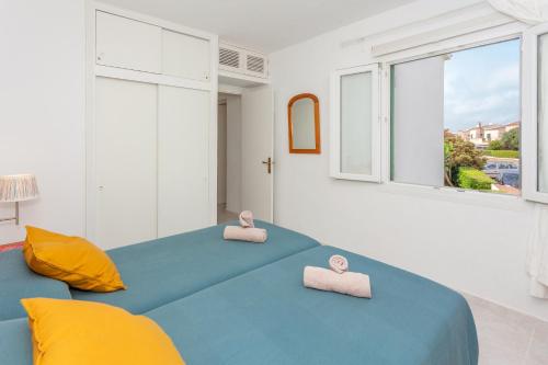 a bedroom with two beds with towels on them at Los Delfines Biniforcat in Ciutadella