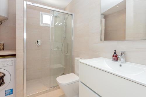 a bathroom with a shower and a toilet and a sink at Los Delfines Biniforcat in Ciutadella