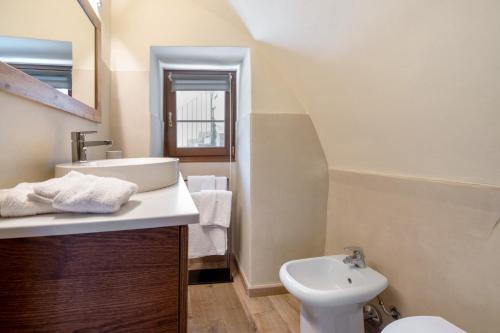 a bathroom with a sink and a toilet at Le Volte - Lago D'Iseo in Pisogne