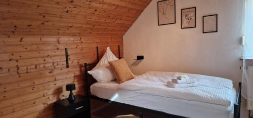 a bedroom with a white bed and a chair at M B Homes Schlatt 2 Worker House in Hechingen