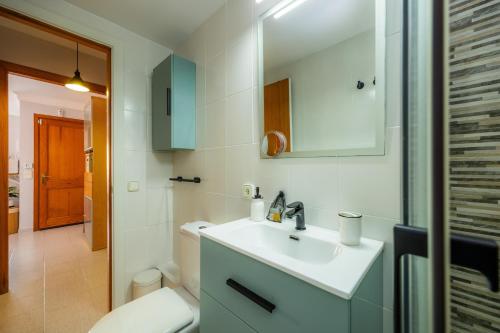 a bathroom with a sink and a toilet at Formentorgloria in Port de Pollensa
