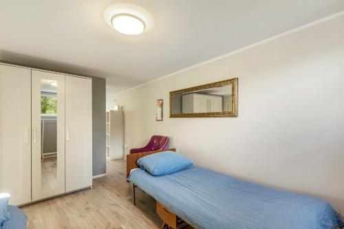 a bedroom with a bed and a mirror on the wall at Green wonder in Friedrichsdorf