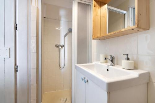 a bathroom with a sink and a shower at Casa Amarela in Tavira