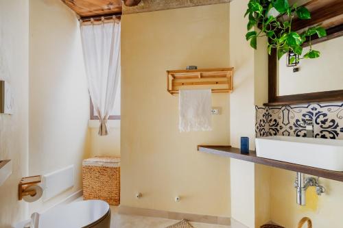 a bathroom with a white toilet and a mirror at Dimora Pisanelli in Specchia