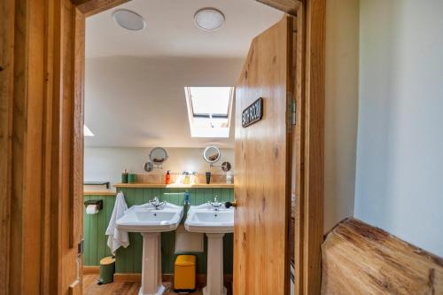 a bathroom with two sinks and a window at L'Atelier de Scarlett - Lannux in Lannux