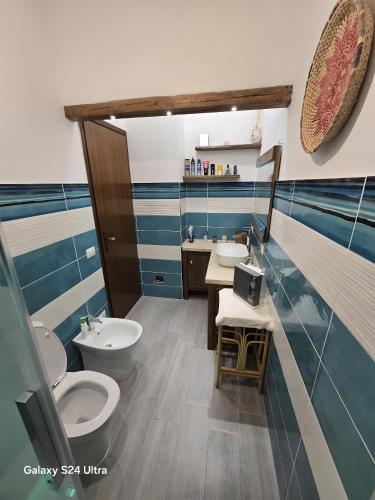 a bathroom with two toilets and a sink at Rosemary House in Olbia