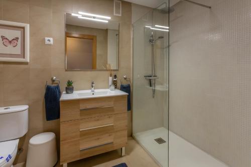a bathroom with a shower and a sink and a toilet at Luxury Pool and Spa - Casa Coco in Casas del Cura