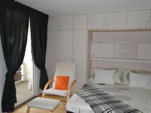 a bedroom with a bed and a chair and a window at Alb Studio in Sankt Blasien in St. Blasien