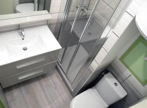 a bathroom with a shower and a toilet and a sink at Appart 7 Laux - Balcon Sud in Les Adrets