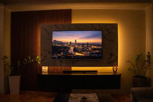 a living room with a tv on a wall at Mitrovi Apartment in Gevgelija