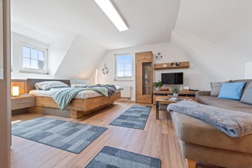 a living room with a bed and a couch at Gertruds Leuchtturm Strandnah in Zingst