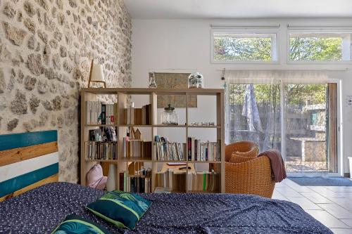 a bedroom with a book shelf and a bed at Gîte L'ancien Préau in Avrillé-les-Ponceaux