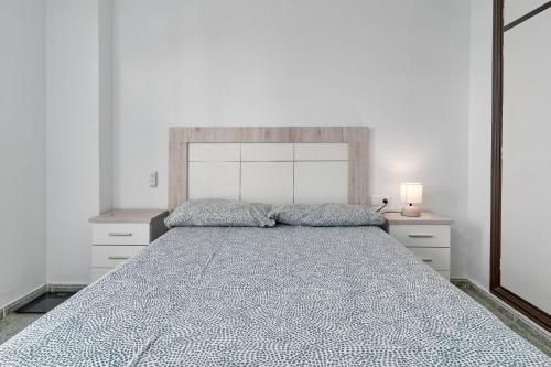 a bedroom with a large bed with two night stands at Apartamento Familiar Torrox A65 in Torrox