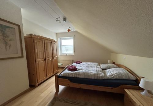 a bedroom with a bed and a window in a attic at Ferienwohnung Moos-Hochsauerland in Olsberg