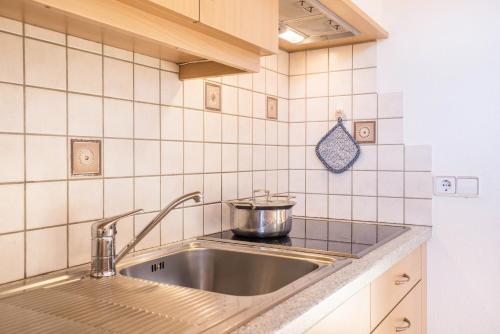 a kitchen sink with a pot on top of it at Kuglerhof Apt 1 in Cadipietra