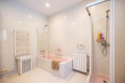 a bathroom with a shower and a tub and a sink at Villa Puerto in Sóller