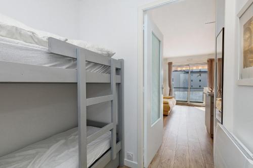 a bedroom with two bunk beds and a hallway at Appart' Chez Suzi, La Baule centre in La Baule