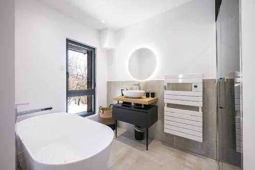 a bathroom with a white toilet and a sink at Black Arves in La Rochette