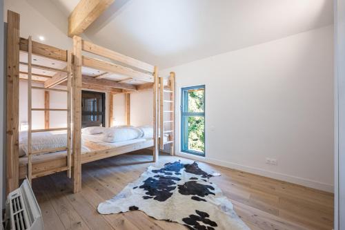 a room with two bunk beds and a rug at Black Arves in La Rochette