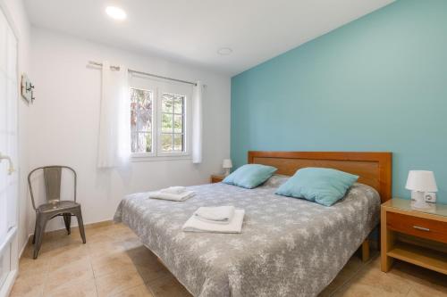 a bedroom with a bed with two towels on it at Safir in Son Bou