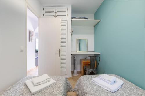 a bedroom with a bed with two white towels on it at Safir in Son Bou