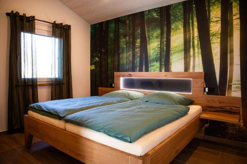 a bedroom with a bed with a painting on the wall at Kleines Glück Wettenberg in Hochdorf