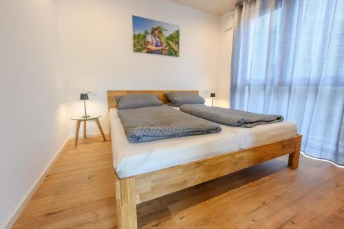 a bedroom with a bed in a room with a window at Ferienwohnung Talblick in Kappelrodeck