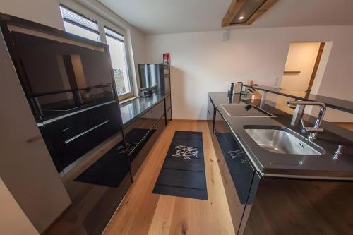 a kitchen with a sink and a counter top at Alpenblick De Luxe in Oetz