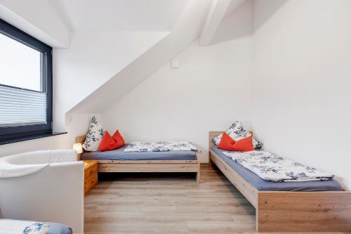 a room with two beds and a window at Deluxe Ferienwohnungen Diana in Radolfzell am Bodensee
