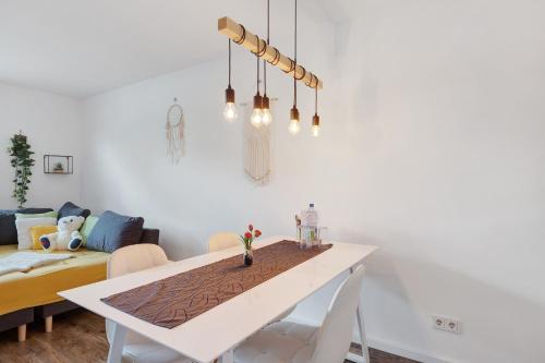 a white dining room with a white table and chairs at Casa Simona in Orsingen-Nenzingen