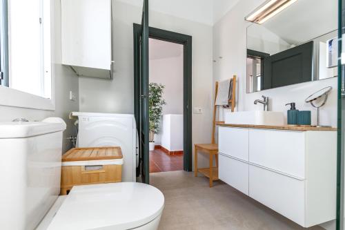 a bathroom with a toilet and a sink at Maison Menorca in Arenal d'en Castell