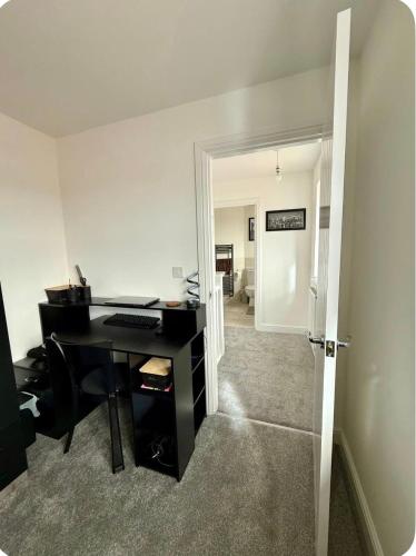 an office with a desk and a computer in a room at Single room in Tamworth in Wigginton