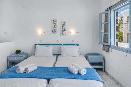 a bedroom with two beds with towels on them at Pico Bello Patmos 26 in Patmos