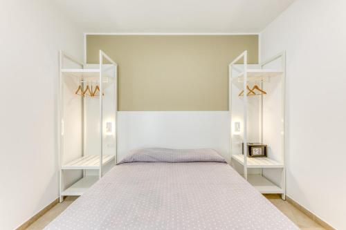a bedroom with white shelves and a bed at Residence Fronte Mare in Ugento