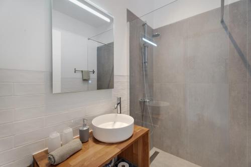 a bathroom with a white sink and a shower at Casa Agua Y Sol I in Poris de Abona