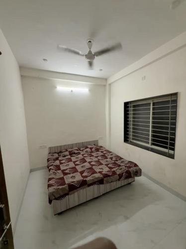 a bedroom with a bed and a ceiling fan at Nahta's Farm Villa in Simrol