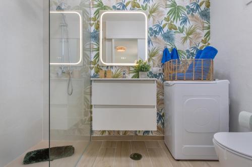 a bathroom with a toilet and a sink and mirrors at Neral relax in Las Playitas