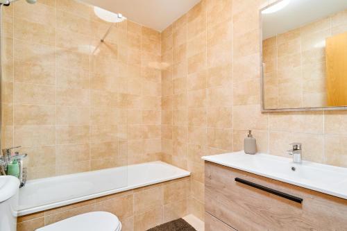 a bathroom with a tub and a sink and a toilet at Marina De El Morche in Torrox