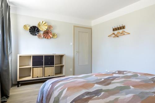 a bedroom with a bed and a book shelf at Au Bretzel in Ostheim
