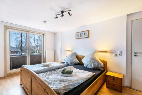 a bedroom with a large bed and a window at Ferienwohnung Seestern in Wester-Ohrstedt