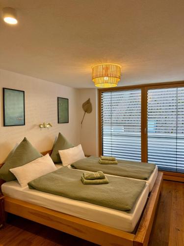 a bedroom with a large bed and a large window at Hangout in Neckartenzlingen
