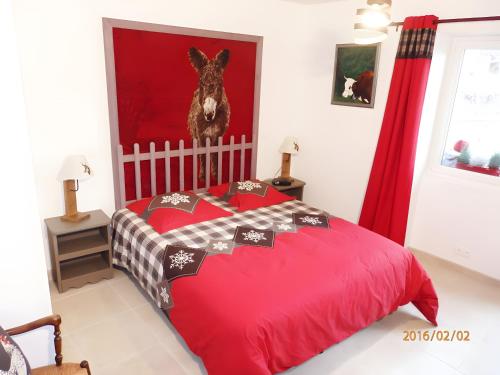 a bedroom with a red bed and red curtains at Gîte Chez Fanfoué in Orcier