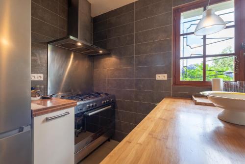a kitchen with a stove and a sink at Villa Delb in Arthez-dʼAsson
