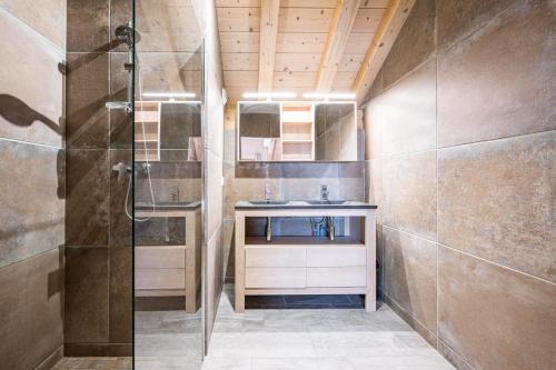 a bathroom with a shower and a sink at Alphonsine Ski Lodge in La Toussuire