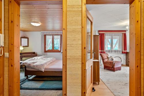a bedroom with a bed and a desk at Stecher's Hüsli in Titisee-Neustadt