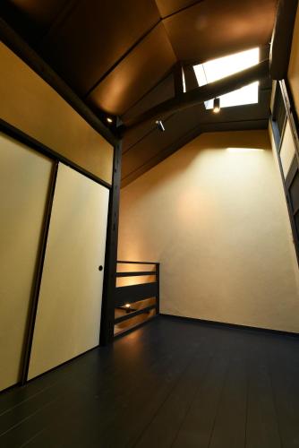 an empty room with two sliding glass doors at Kuraya Kamigojocho in Kyoto