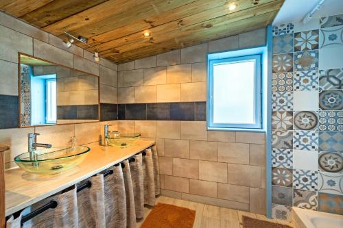 a bathroom with two sinks and two mirrors at Ty Reuniou - La Grange in Cléder